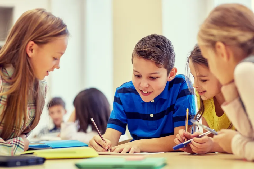 Dev at his desk with his classmates